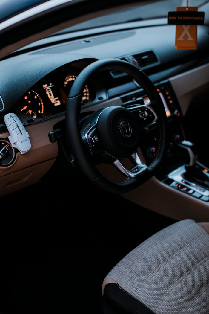 services-01 Interior view of a Volkswagen vehicle featuring a modern dashboard and steering wheel design.